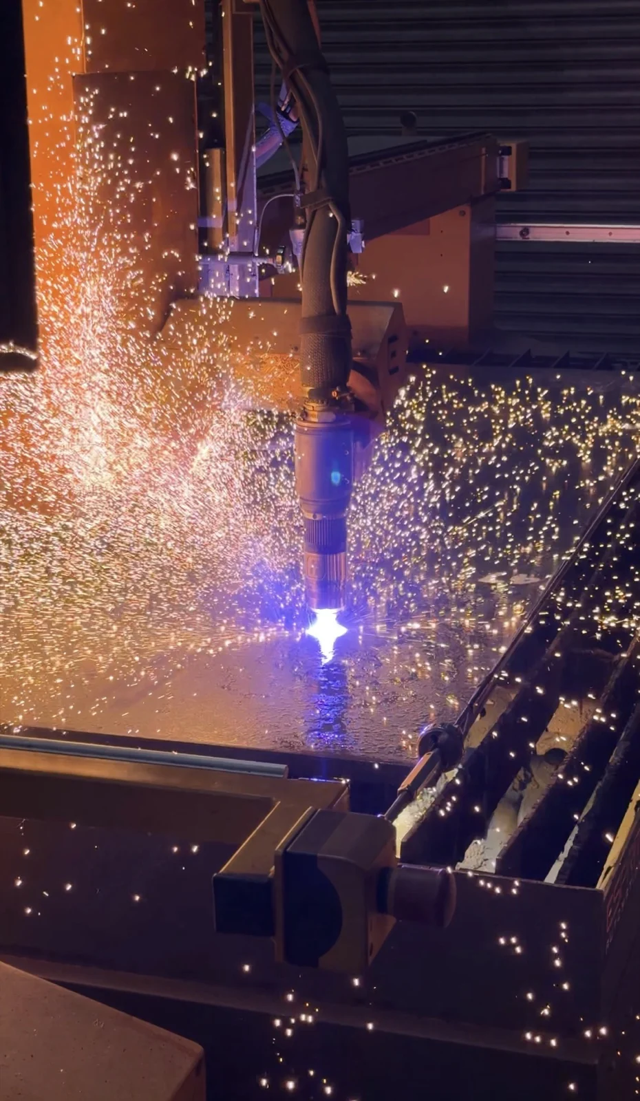 Sparks from automated welding in the manufacturing facility