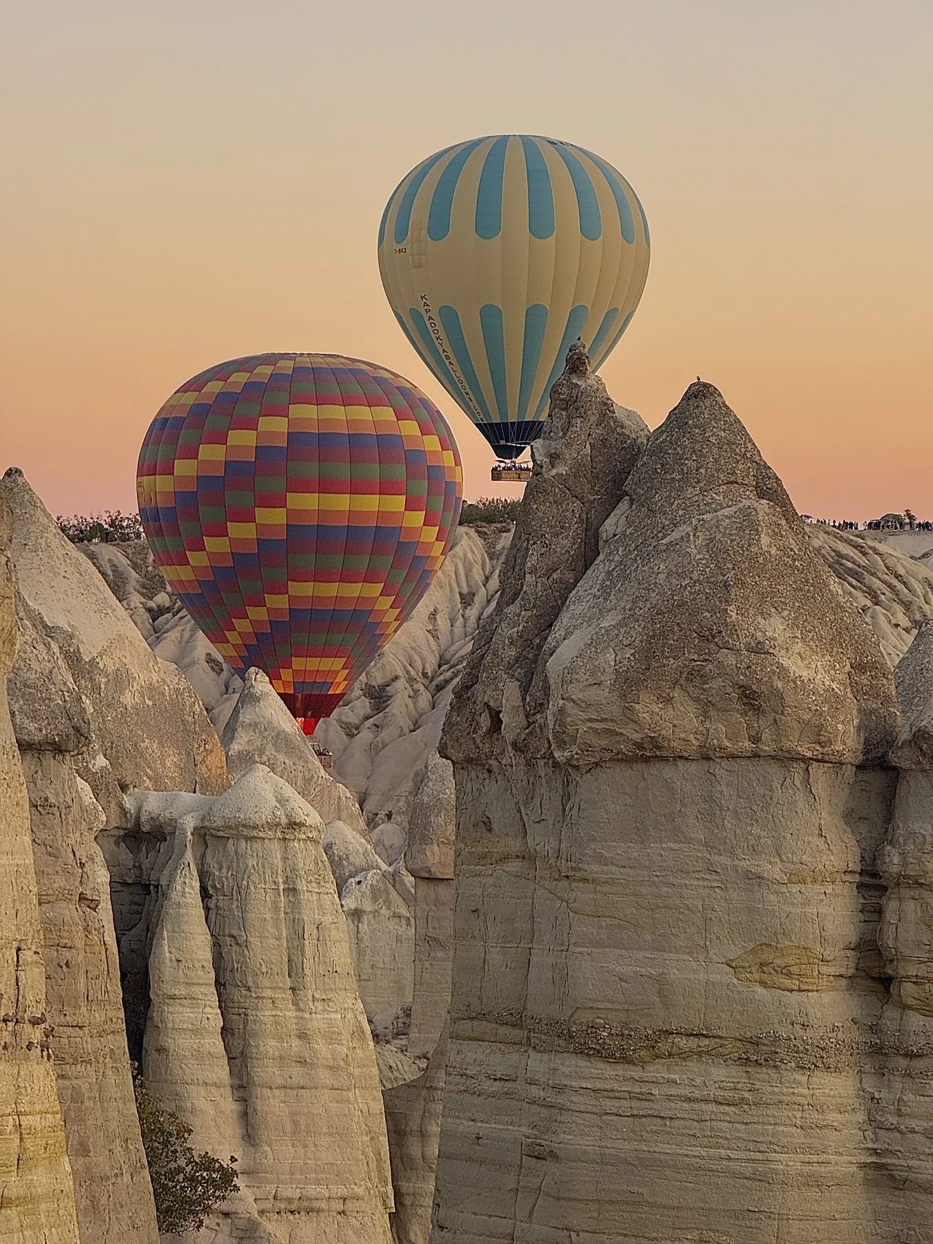 Hot-air balloons rising above the rock formations of Cappadocia