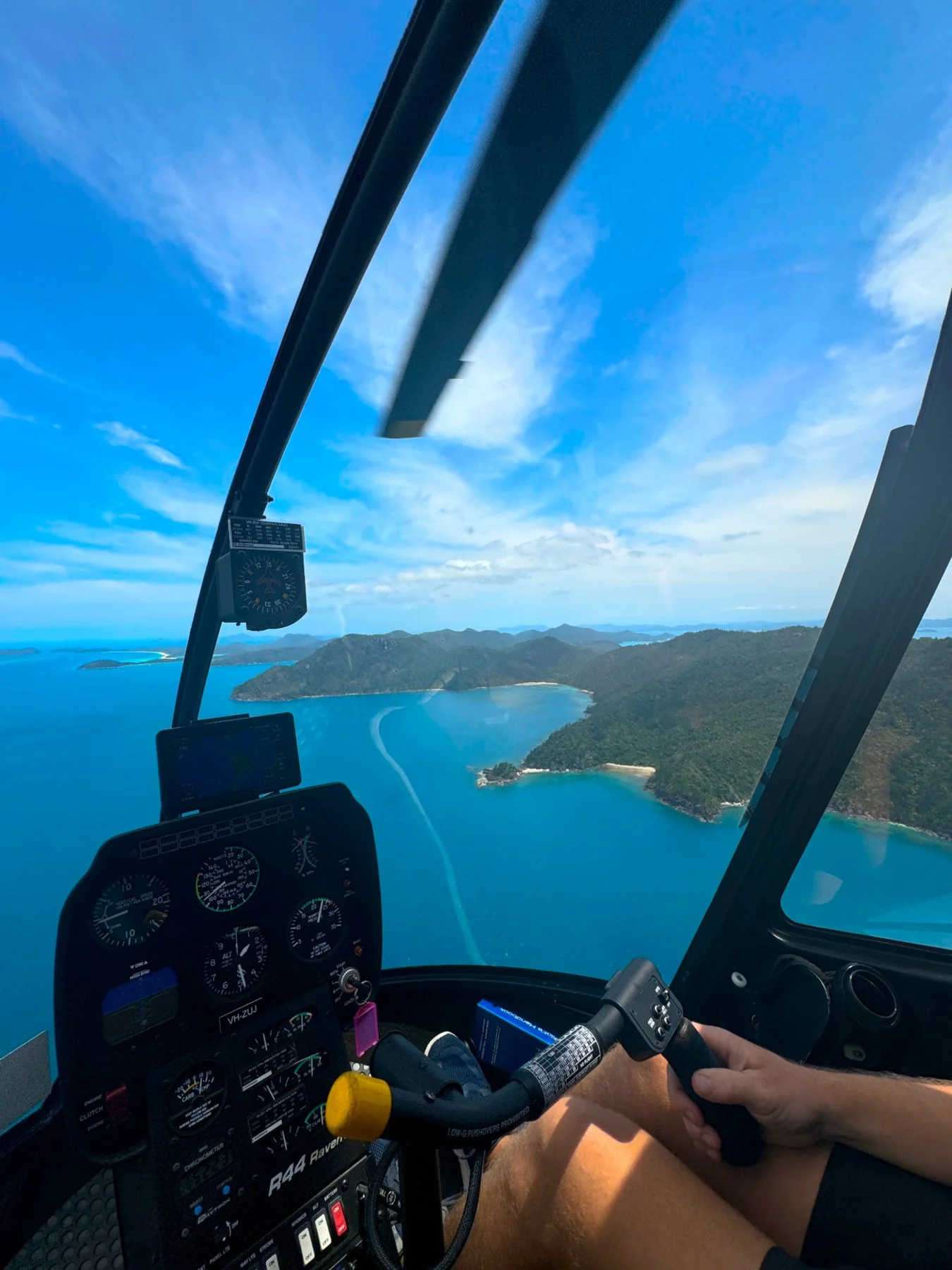 Island coastline and blue sea viewed from a helicopter