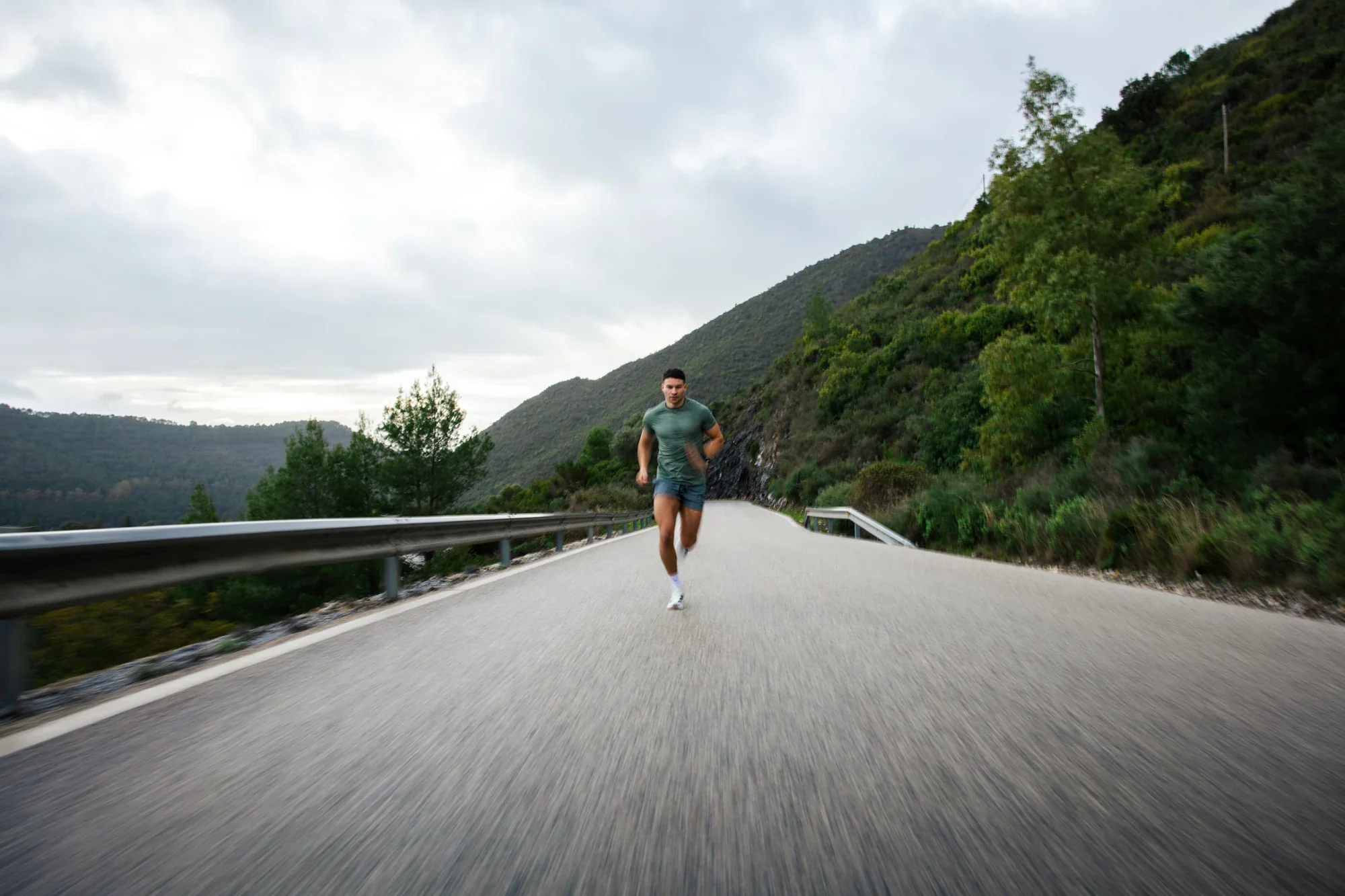 Murray Clark running on a mountain road beside a lake