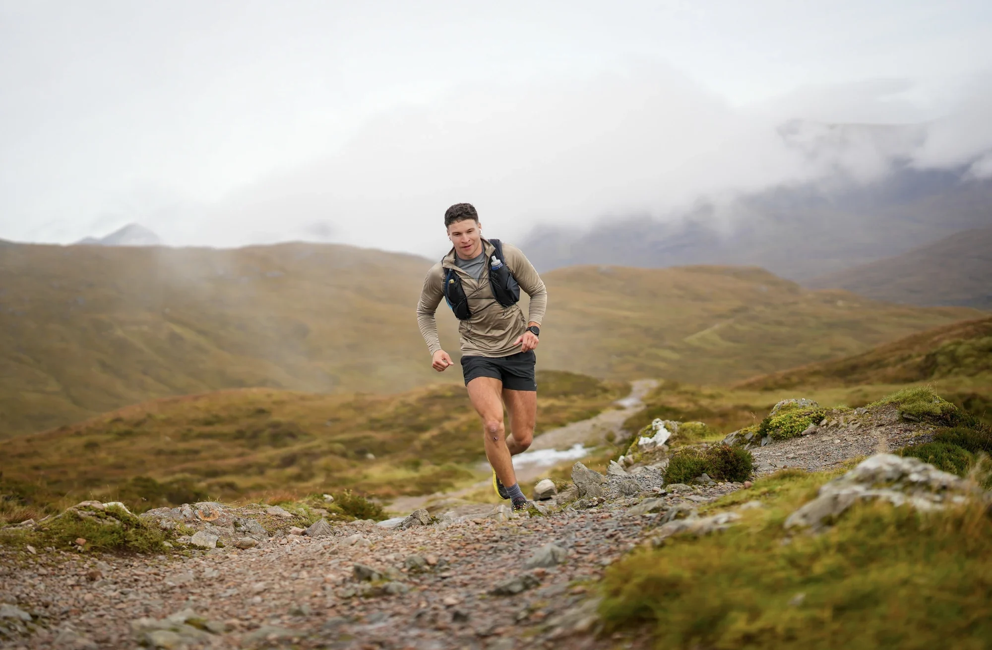 Murray Clark running uphill on a rocky mountain trail